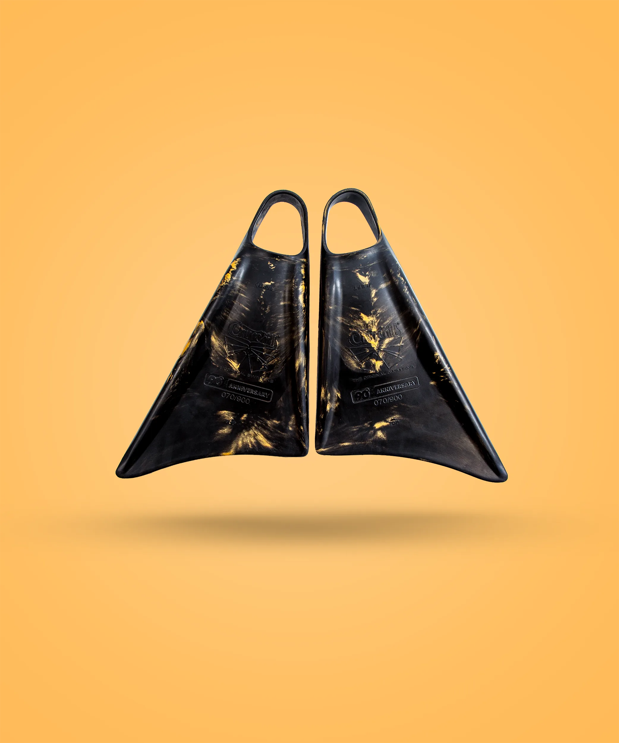 Black and gold Churchill swimfins, 90th anniversary edition, on orange background