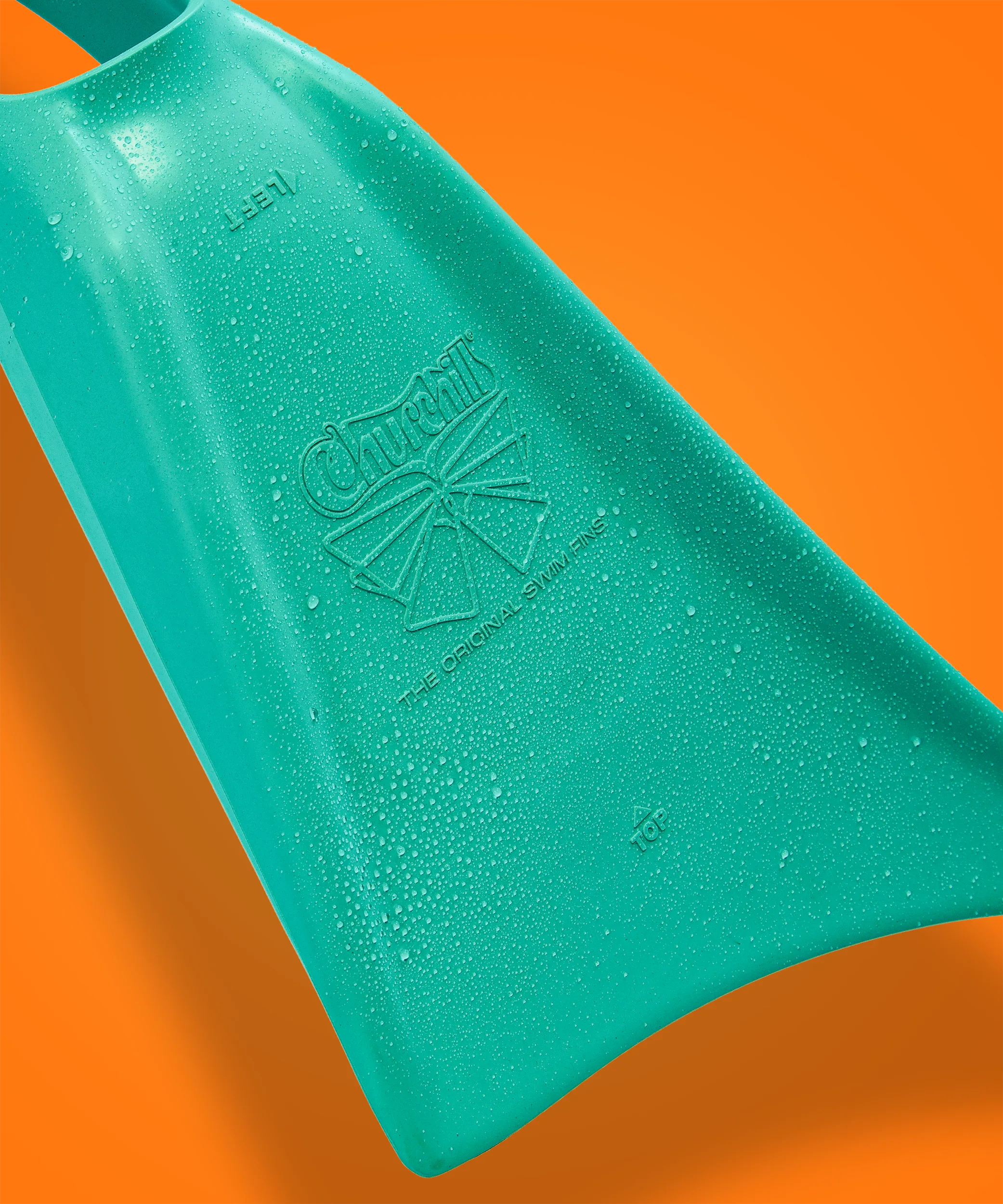 Teal Churchill swim fin with water droplets, branded 'The Original Swim Fins' on orange background