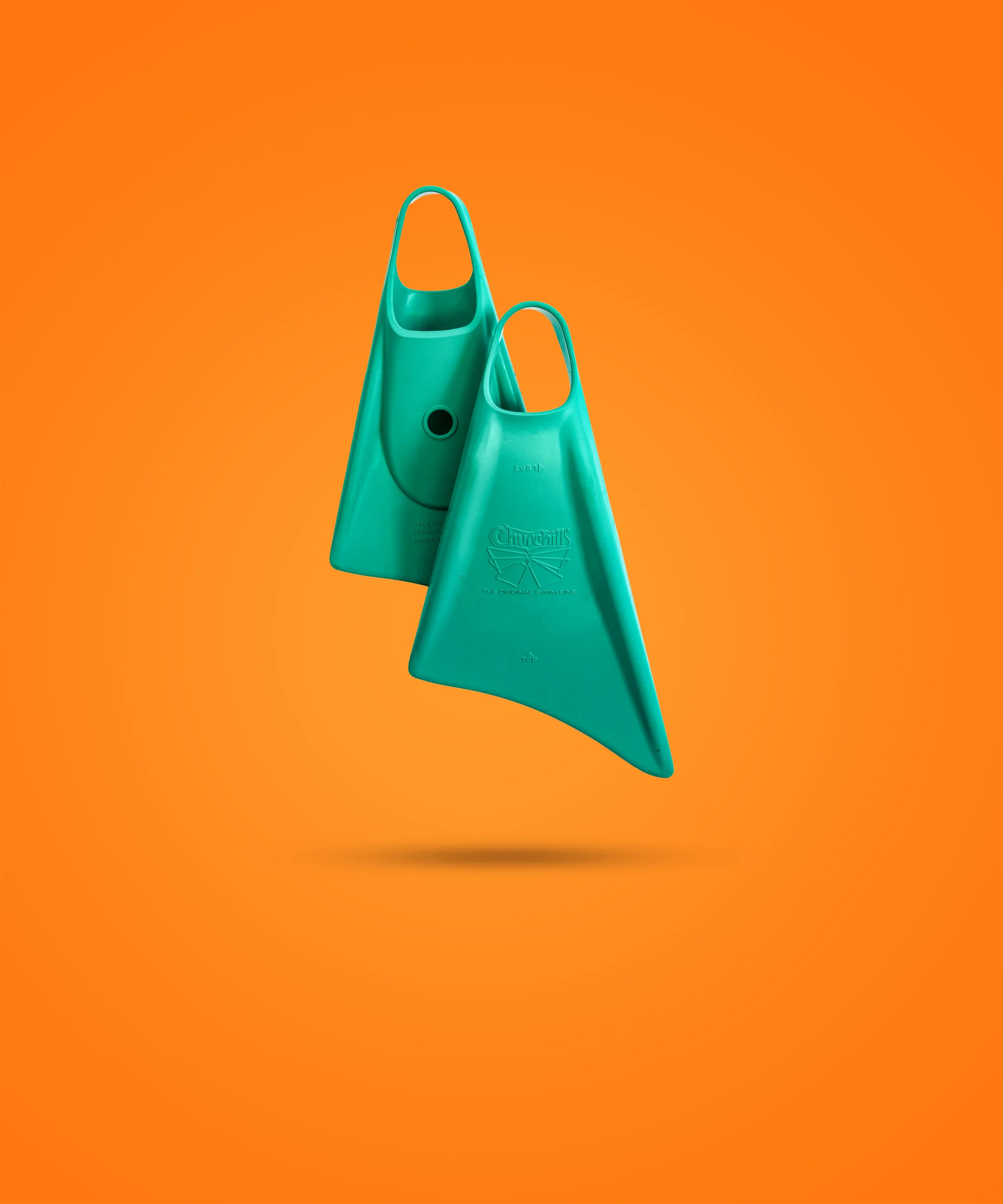 Teal Churchill swimfins against vibrant orange background, showcasing original design and durable build for swimming training.