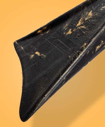 Black swimfin with water droplets and gold accents, showcasing durable design for swimming performance