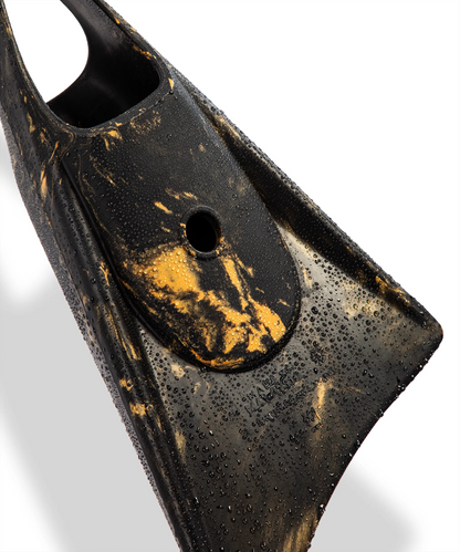 Black and gold swimfin with water droplets, showcasing durable design for swimming and diving