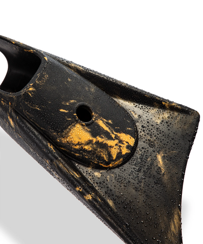 Black and gold swimfin with water droplets, showcasing durable design for swimming and diving