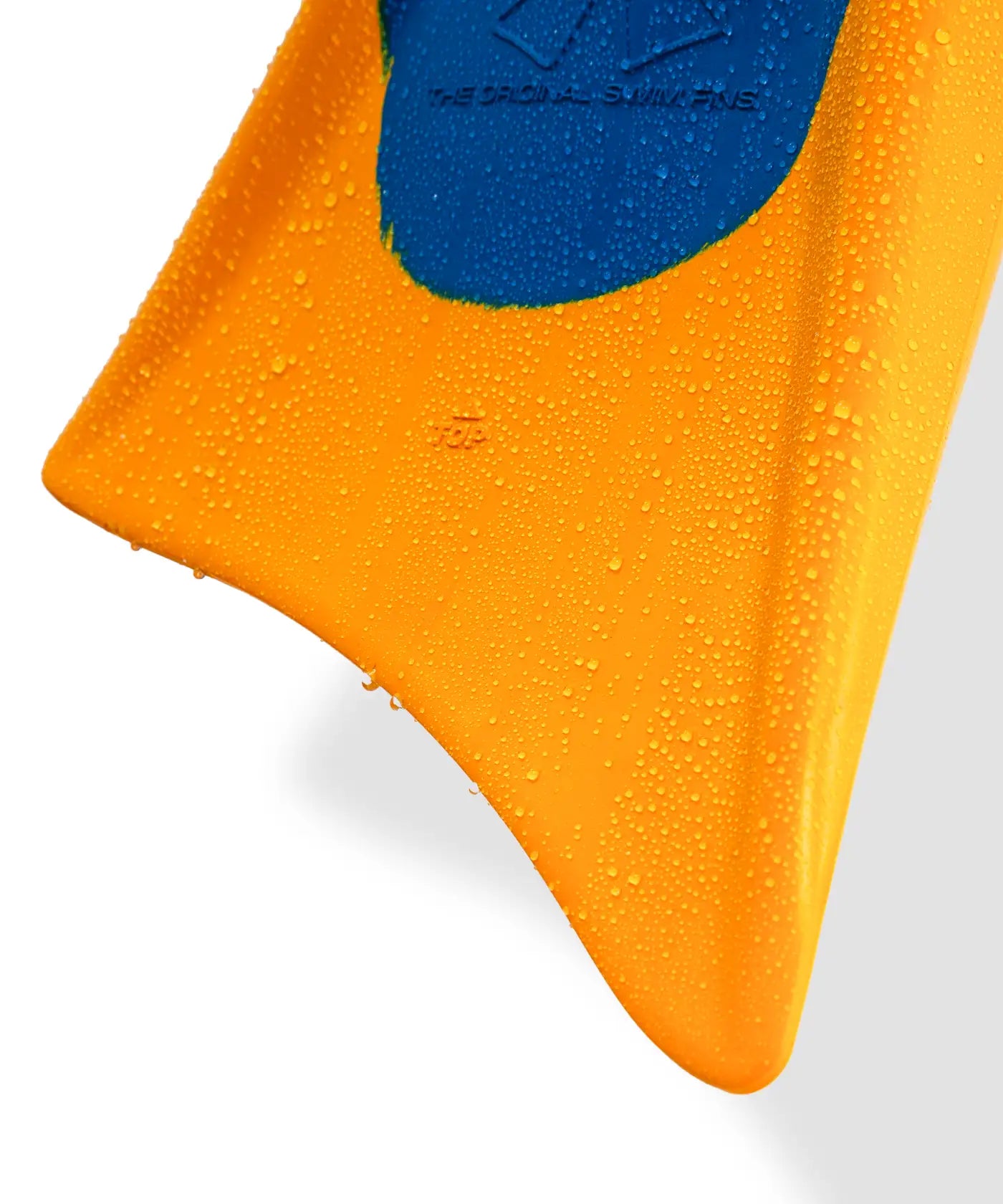 Vibrant orange swim fin with blue grip, water droplets highlighting durability and performance.